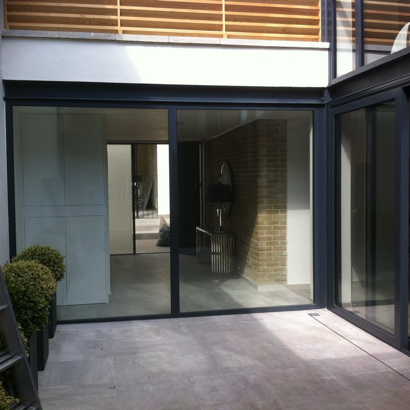 Floor-to-ceiling sliding doors opening to courtyard in Watford