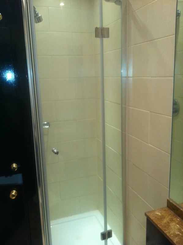 Frameless glass shower enclosure with chrome fittings in Watford