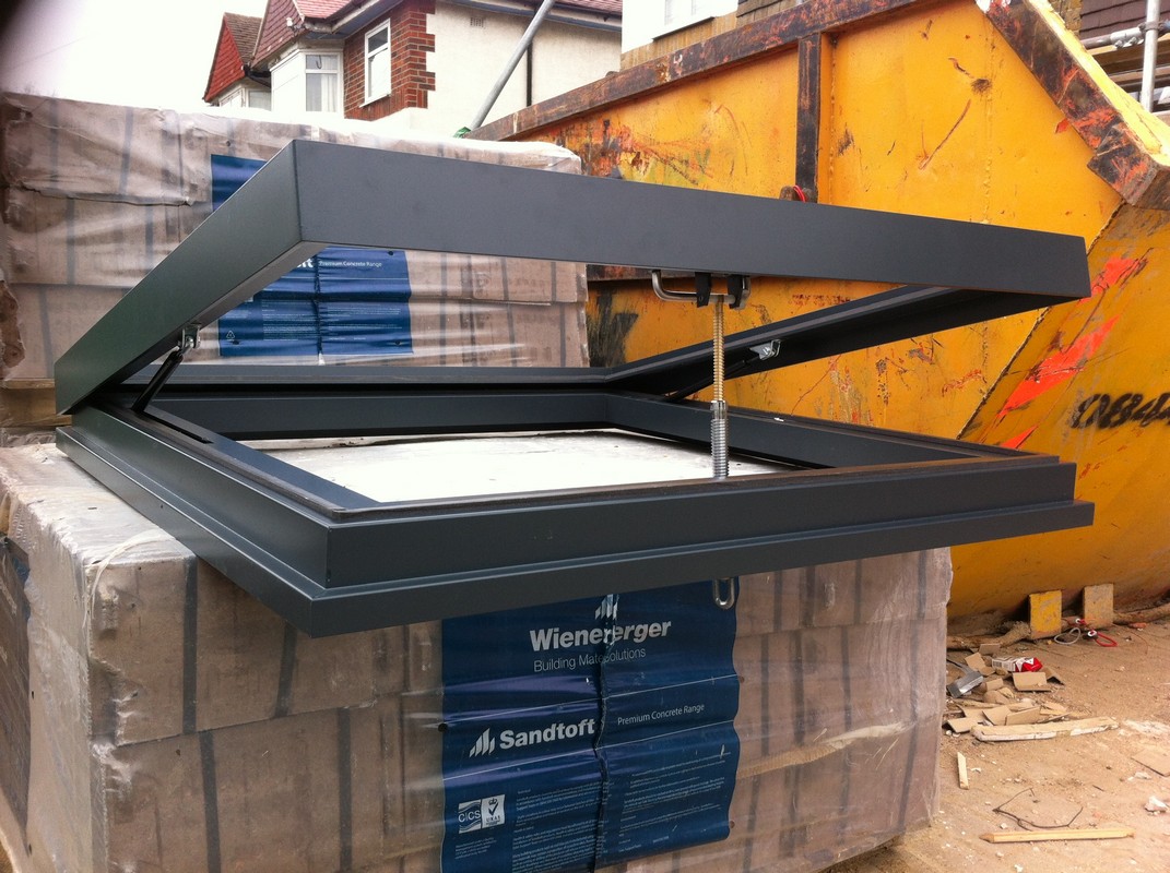 Opening flat roof skylight in anthracite grey installed in Watford
