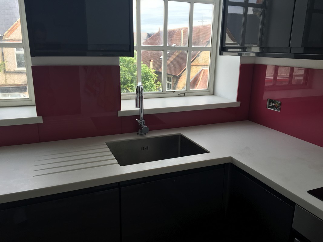 Deep plum coloured glass splashback in modern Watford kitchen